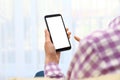 Woman holding smartphone with blank screen on blurred background, closeup of hands Royalty Free Stock Photo