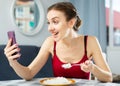 Woman having video call while rice at home Royalty Free Stock Photo