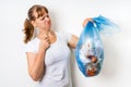 Woman holding a smelly garbage bag Royalty Free Stock Photo