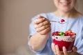 Woman  holding smoothie bawl with organic yogurt, berries and mint. Homemade yogurt in girl`s hands served with berries Royalty Free Stock Photo