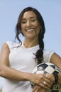 Woman Holding Soccer Ball low angle portrait.