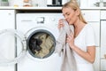 Young woman with clean laundry at home Royalty Free Stock Photo