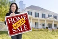 Woman Holding Sold Home Sale Sign in Front of House Royalty Free Stock Photo