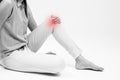 Woman holding on sore knee on white. Royalty Free Stock Photo