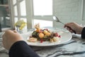 A woman holding spoon and fork and preparing to eat mixed fruits Royalty Free Stock Photo