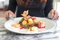 A woman holding spoon and fork and preparing to eat mixed fruits Royalty Free Stock Photo