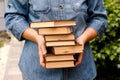 Woman holding a stack books in her hands outdoors Royalty Free Stock Photo