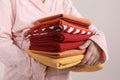 Woman holding stack of clean bed linens on beige background, closeup Royalty Free Stock Photo