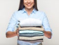 Woman holding stack of folded clothes. Royalty Free Stock Photo