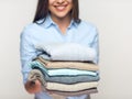 Woman holding stack of folded clothes. Royalty Free Stock Photo