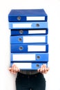 Woman holding stack of folders