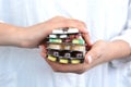 Woman holding a stack of pills blisters