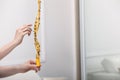 Woman holding sticky insect tape with dead flies indoors, closeup. Space for text Royalty Free Stock Photo