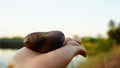 Woman holding stone in hand, integration of working life, burdens and women`s power.