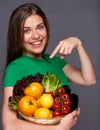 woman holding straw basket with summer vegetables pointing finger. Royalty Free Stock Photo