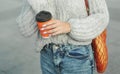 woman holding a string bag and paper cup of coffee Royalty Free Stock Photo