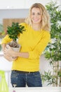 Woman holding succulent plant over table in yard