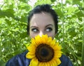 Woman holding sunflower to her face Royalty Free Stock Photo