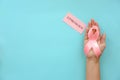 Woman holding symbolic ribbon of breast cancer Royalty Free Stock Photo