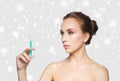 Woman holding syringe with injection over snow Royalty Free Stock Photo