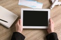 Woman holding tablet with blank screen over table. Travel agency Royalty Free Stock Photo