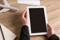 Woman holding tablet with blank screen over table. Travel agency Royalty Free Stock Photo