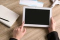 Woman holding tablet with blank screen over table. Travel agency Royalty Free Stock Photo