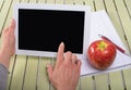 Woman holding a tablet computer with an apple Royalty Free Stock Photo