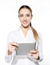 Woman holding tablet computer isolated on white background. working on touching screen. Casual smiling caucasian woman. Royalty Free Stock Photo