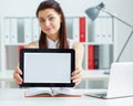 Young smiling business woman holding tablet with copy space for text or picture. Stylish modern office workplace on a