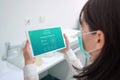 Woman holding tablet with coronavirus positive test concept