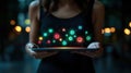 Woman holding tablet with glowing app icons at night Royalty Free Stock Photo