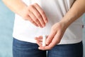 Woman holding tampon against blue background Royalty Free Stock Photo