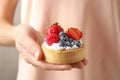 Woman holding tart with different berries, . Delicious pastries Royalty Free Stock Photo