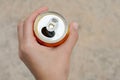 Woman holding tasty open canned beverage against blurred background, top view