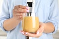 Woman holding tasty pear juice in glass, closeup