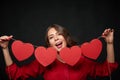 Woman holding thread with four heart shapes