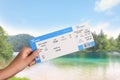 Woman holding ticket near bay, closeup. Travel agency service