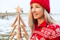 Woman holding a timber Christmas Tree, Christmas season, Christmas in July themes