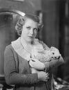 Woman holding tiny puppy Royalty Free Stock Photo