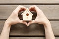 Woman holding tiny wooden house