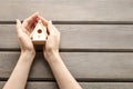 Woman holding tiny wooden house