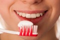 Woman holding toothbrush in front of teeth promoting mouth hygiene for healthy teeth. Royalty Free Stock Photo