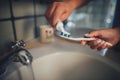 Woman holding toothbrush and man squeezing toothpaste Royalty Free Stock Photo