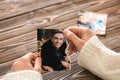 Woman holding torn part of photo with her ex-husband. Concept of divorce