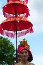 Woman holding a traditional umbrella during the ceremony of Nyepi. Bali