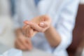 Woman holding transparent contact lens on blurred background