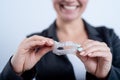 A woman is holding a transparent plastic mouth guard. Orthodontist's bite correction device Royalty Free Stock Photo