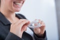 A woman is holding a transparent plastic mouth guard. Orthodontist's bite correction device Royalty Free Stock Photo