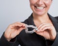 A woman is holding a transparent plastic mouth guard. Orthodontist& x27;s bite correction device Royalty Free Stock Photo